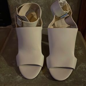 Calvin Klein Ivory Leather peep toe sandal with gold hardware.